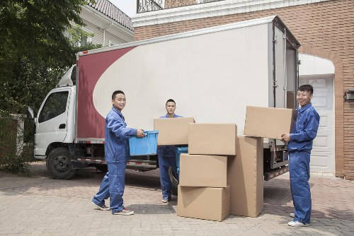Removal van and moving team in a residential street in The Hyde