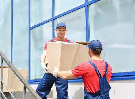 Furniture and boxes being transported by a local van service