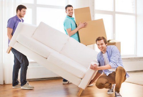 Staff member lifting furniture with careful moving technique