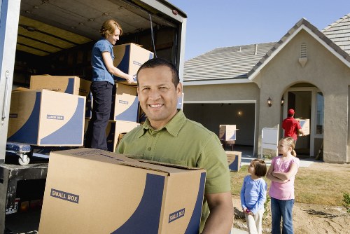 Loading boxes and furniture into a removal van