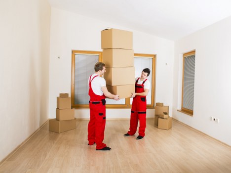 Removal crew transporting business equipment during a local relocation
