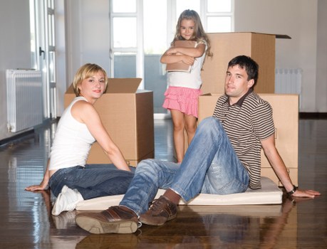 Professional movers carrying furniture through a residential property
